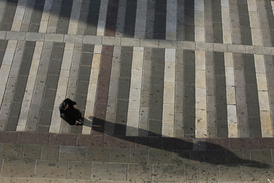 High angle view of man walking on zebra crossing