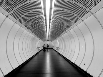 Family walking in illuminated tunnel