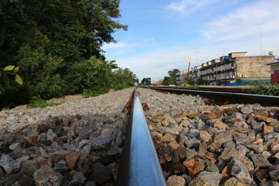 Surface level of railroad tracks against sky