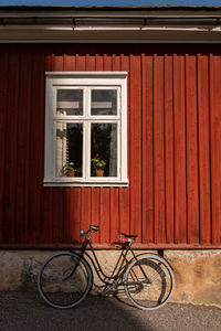 Bicycle by window of building