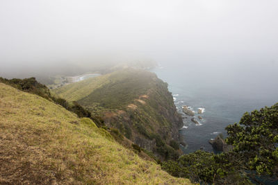 High angle view of sea and mountains against sky