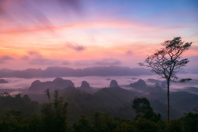 Scenic view of silhouette mountains against sky at sunset