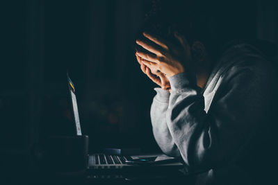 Midsection of businessman using laptop on table