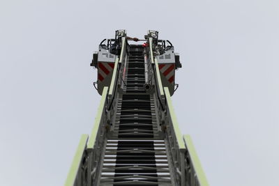 Low angle view of crane against clear sky