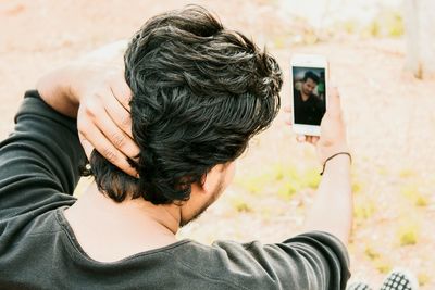 Close-up of man holding mobile phone