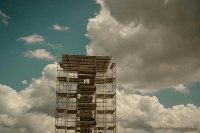 Low angle view of building against cloudy sky