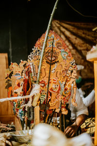 People holding umbrella at temple outside building