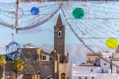 Clock tower amidst buildings in city