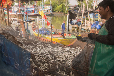 Side view of people working at market