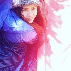Portrait of young woman in warm clothing outdoors
