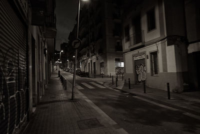 Street amidst buildings in city at night