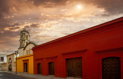 Low angle view of building against sky during sunset