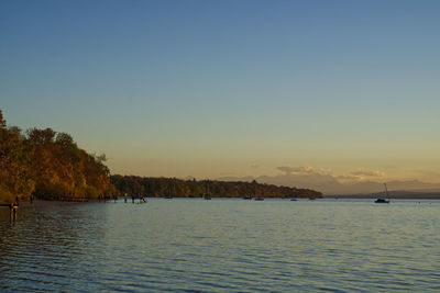 Scenic view of sea against clear sky during sunset