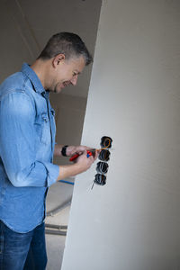 Side view of man working at home