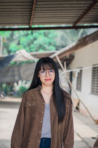 Portrait of young woman standing outdoors