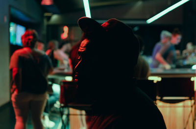 Side view of thoughtful man sitting in nightclub