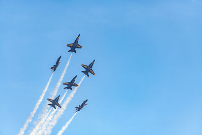 Low angle view of airshow against sky