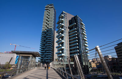 Low angle view of buildings against clear blue sky