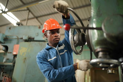 Rear view of man working in factory