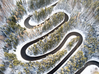 High angle view of winding road amidst trees