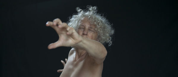 Close-up of human hand against black background