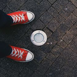 Low section of person standing on tiled floor