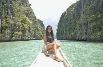 Portrait of young woman sitting on boat in sea