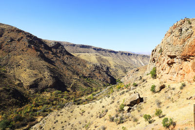 Scenic view of rocky mountains against clear blue sky, norawank monastery in armenia