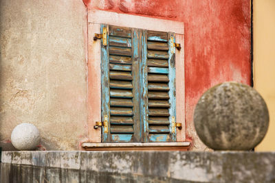 Close-up of old window on wooden wall