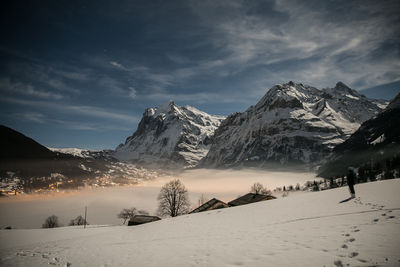 Scenic view of snow covered mountains against sky