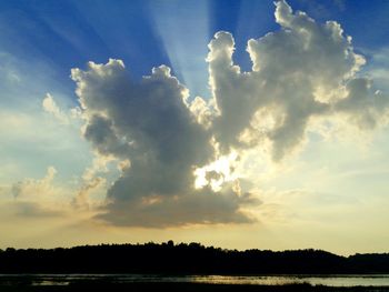 Scenic view of calm lake against cloudy sky