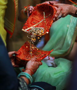 Midsection of man holding flower