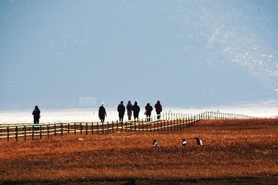 People on field against sky