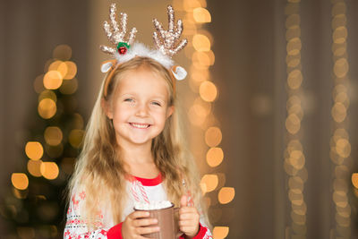 Portrait of smiling girl holding hot chocolate