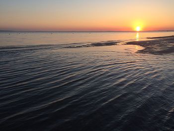 Scenic view of sea against clear sky during sunset