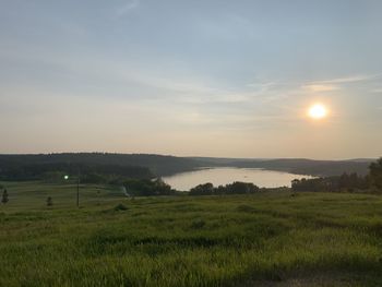 Scenic view of field against sky during sunset
