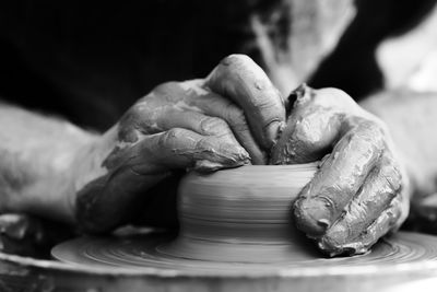 Hands of a potter. potter making ceramic pot on the pottery wheel