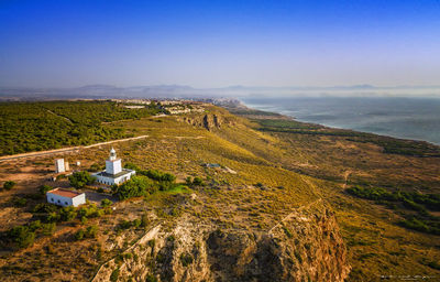 High angle view of land and sea against sky