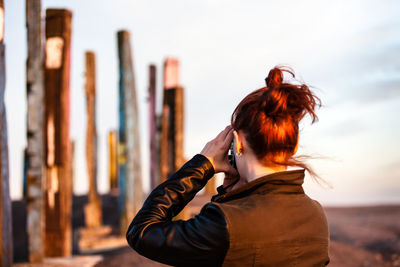 Rear view of woman photographing sculptures