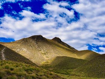 Low angle view of mountain against cloudy sky