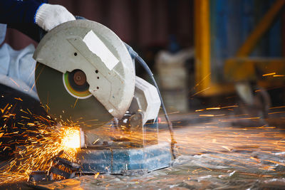 Cutting of a steel with splashes of sparks, metal processing with angle grinder. 