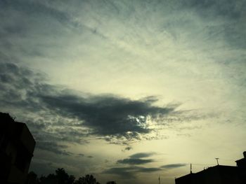 Low angle view of building against cloudy sky