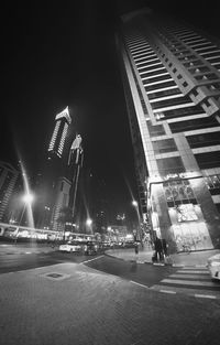 Low angle view of skyscrapers lit up at night