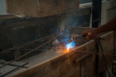 Cropped hand welding rod in factory