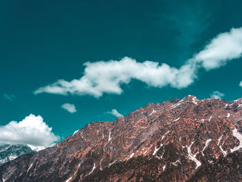 Low angle view of rocky mountains against sky