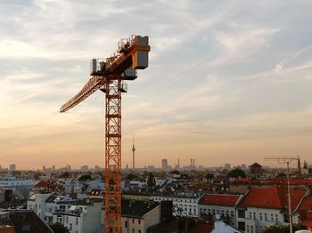 Aerial view of buildings against sky during sunset