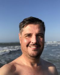 Portrait of man standing at beach