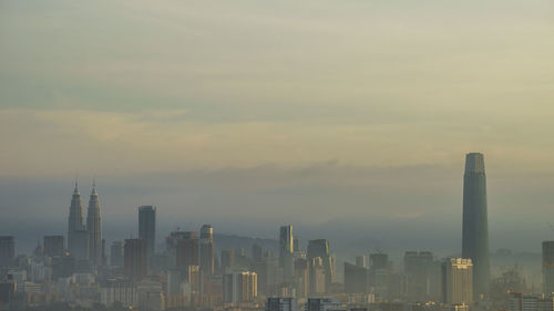 Kuala lumpur morning mist with yellow sunlight.