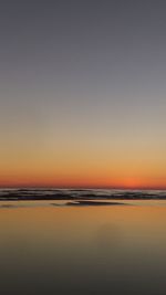 Scenic view of sea against clear sky during sunset