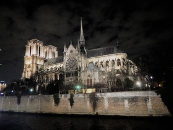 Low angle view of illuminated cathedral against sky at night